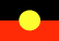 Image of the Australian First Nations black and red flag with a yellow circle centre. The flag sits alongside the Torres Strait Islander Peoples flag and the LGBTQIA+ flag