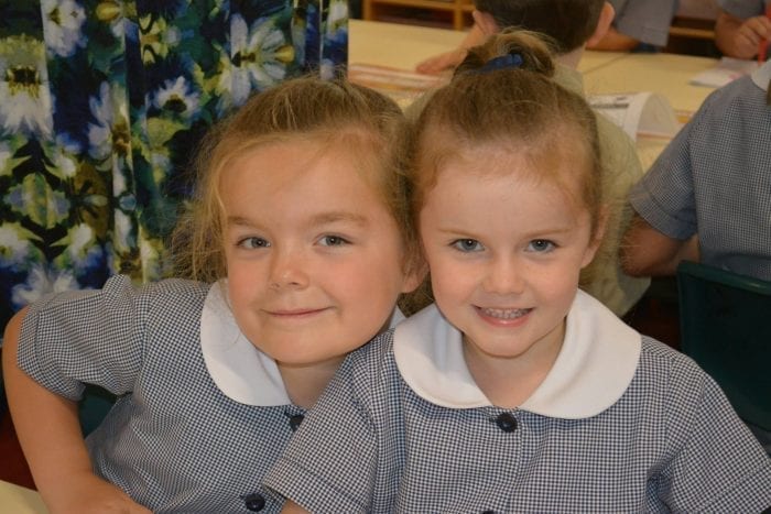 Two primary school aged Anglican School children in class