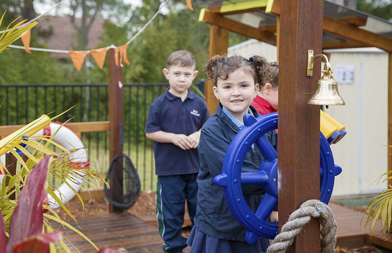 A group of Newcastle Anglican Early Learning Centre kids play outdoors on ship themed outdoor play equipment