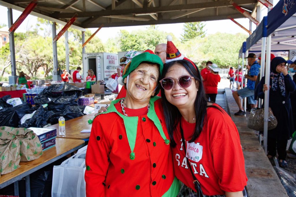 Two happy women enjoy Christmas Lunch